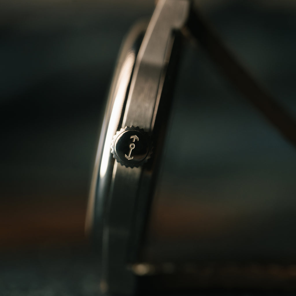 Close-up of a watch case with crown