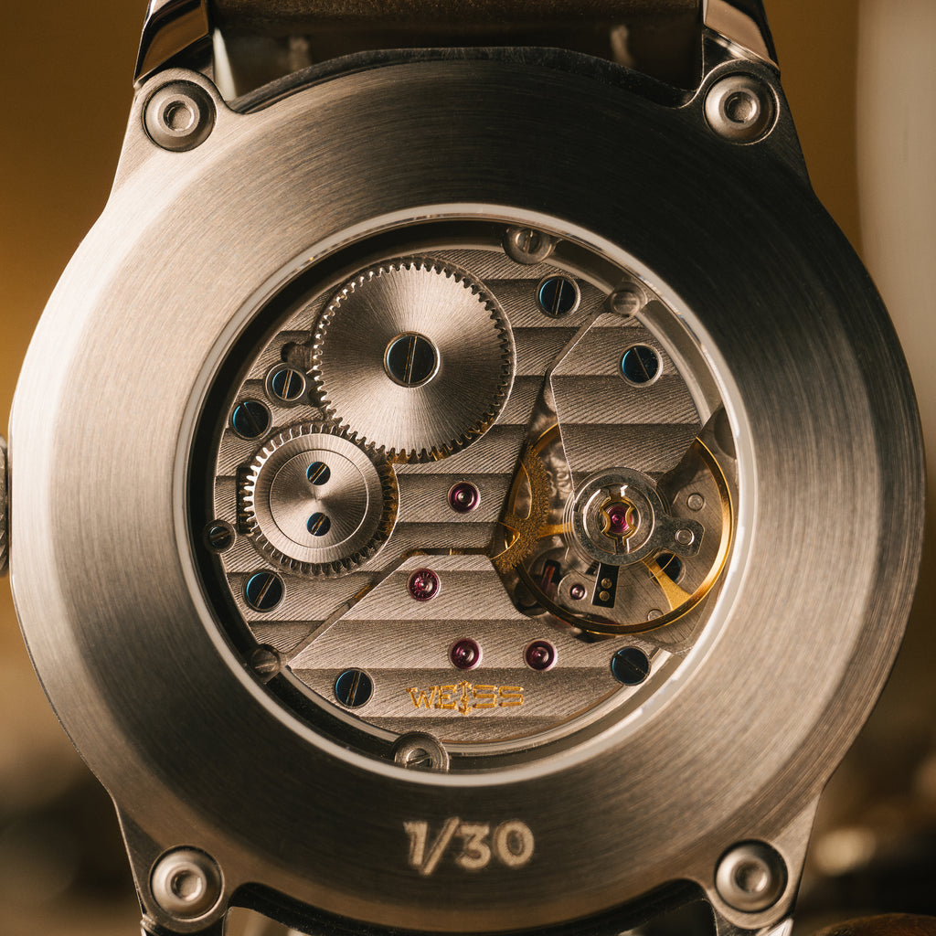 Close-up of a mechanical watch movement with weiss on a blurred background